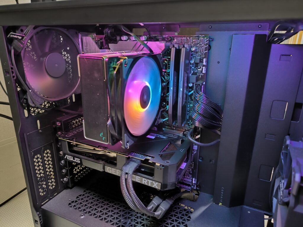 自作PC内部の様子。CPUファンがカラフルに光って回転している。